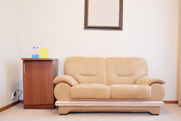 Beige sofa in hotel room