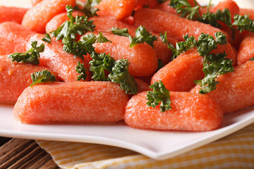 Glazed carrots with parsley on a plate macro. horizontal