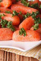 Glazed carrots with parsley on a white plate macro. vertical