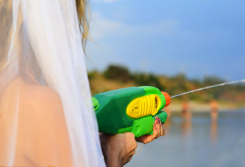 Bride shooting a water pistol