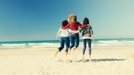 Fototapeta na wymiar Three best friends jumping at seaside