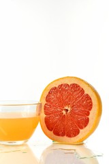 Sliced half of grapefruit and juice