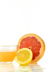 Sliced half of grapefruit and juice
