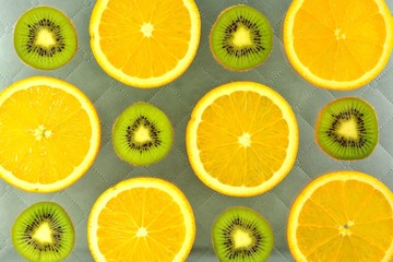 Fototapeta na wymiar Background of different kinds citrus fruits and kiwis