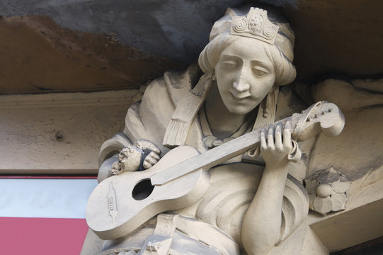 Sculpture of bard playing the guitar in Prague