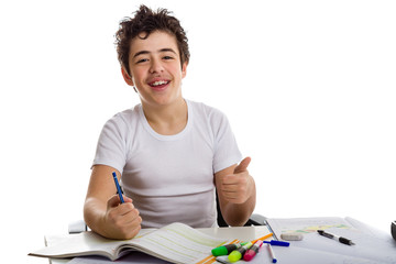 Fototapeta na wymiar teenager boy on homework smiling and showing thumb