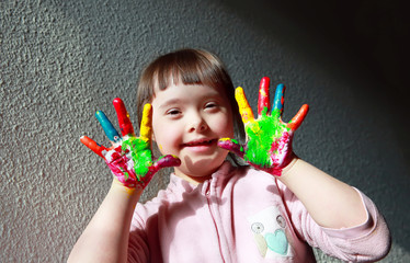 Cute little girl with painted hands.