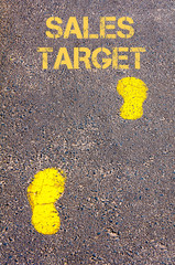 Yellow footsteps on sidewalk towards Sales Target message