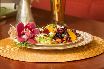Salad on China Plate with Flower and Fruit.
