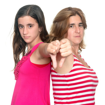 Girl and her mother doing thumbs down hand gesture