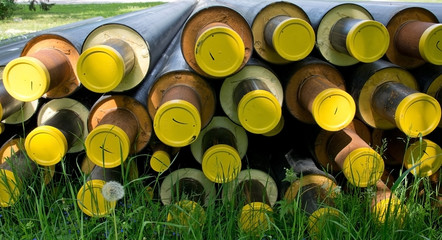 Construction tubes with yellow lids and rust.
