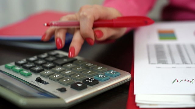 businesswoman working with calculator in office