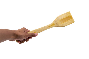 Human hand hold wooden spoon isolated on a white background