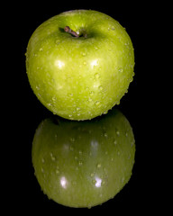 Crisp apple with a stem and water on it