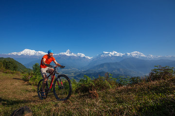 Fototapeta na wymiar Biker-boy in Himalaya mountains, Anapurna region