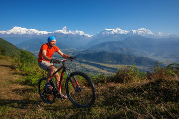 Obraz na płótnie Canvas Biker-boy in Himalaya mountains, Anapurna region