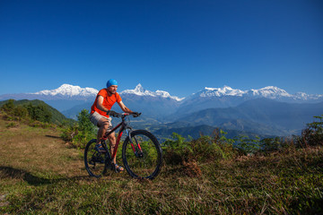 Fototapeta na wymiar Biker-boy in Himalaya mountains, Anapurna region