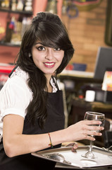 beautiful young waitress girl serving a drink