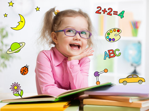 Funny Smart Kid In Glasses Reading Book In Kindergarten