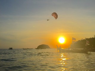 Kata beach sunset skydiver