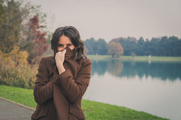 Beautiful young woman posing in a city park