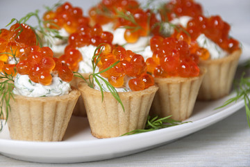 Caviar red fish  with  cream in small tartlets.
