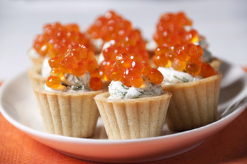Caviar red fish  with  cream in small tartlets.