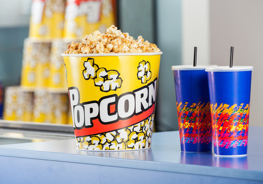 Popcorn Bucket With Drinks On Concession Counter
