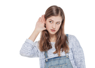 Fototapeta premium Young teenage fashion girl holds his hand near his ear and liste