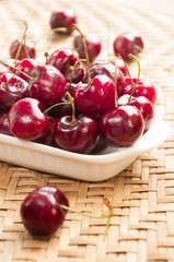 Fototapeta na wymiar Fresh cherries in bowl on table