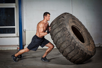 crossfit training - man flipping tire