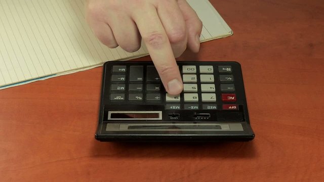 Clumsy man is pushing calculator buttons