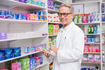 Senior pharmacist using tablet pc