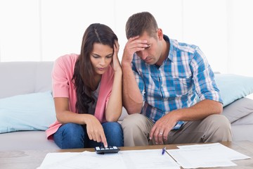 Tensed couple calculating home finances
