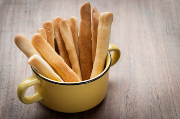 Breadsticks on wooden background.