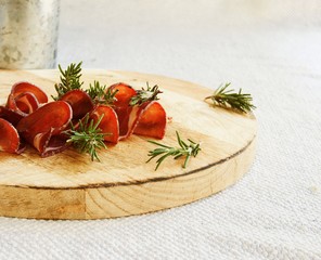 meats with rosmary on a wooden board