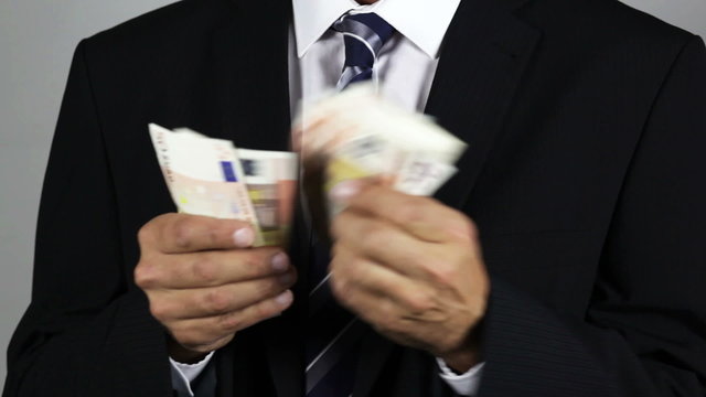 Unrecognisable businessman counting euro banknotes