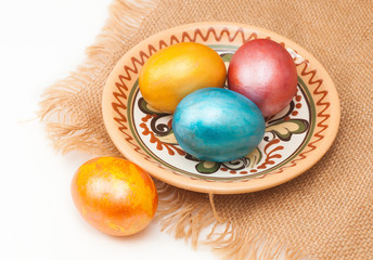 painted eggs for Easter, in plate on canvas