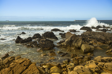 Fototapeta na wymiar Surf at rocky ocean coast. Atlantic ocean, Portugal.