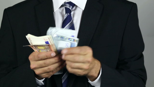 Unrecognisable businessman counting euro banknotes