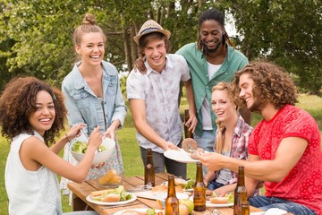 Happy friends in the park having lunch