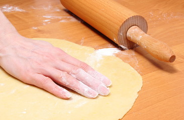 Hand of woman preparing dough for yeast cake