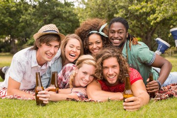 Happy friends in the park having picnic