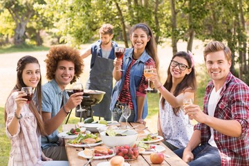 Happy friends in the park having lunch