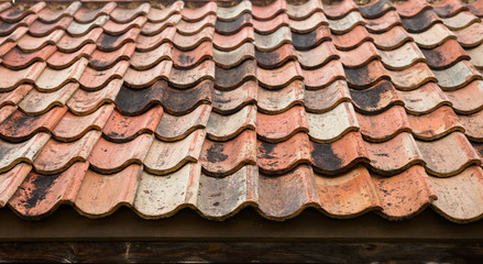 The old roof covered with orange tiles