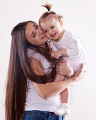 The young mother with long brown hair holding a baby isolated