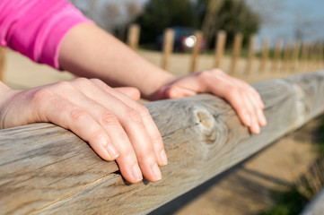 hands over a wooden fence