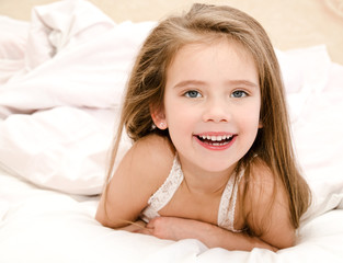 Adorable smiling little girl waked up