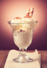 Ice cream in the glass on the table.Vintage retro hipster style