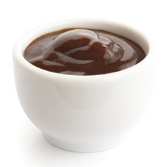 English brown sauce in small white dish.